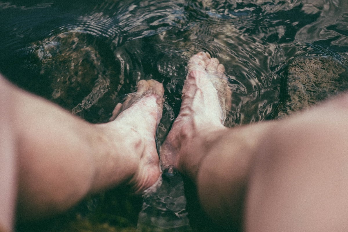 Man soaking feet in water