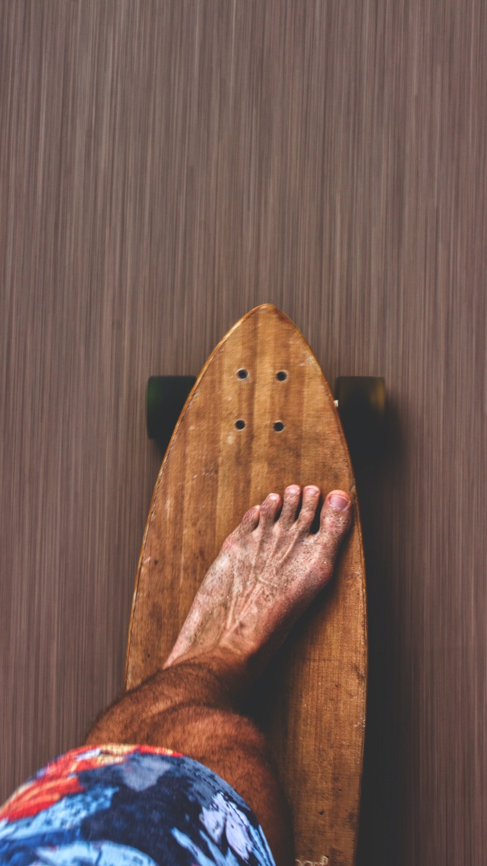man's bare feet on skateboard
