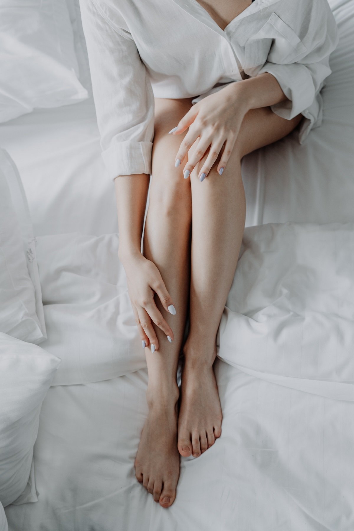 Woman massaging her sore leg muscles