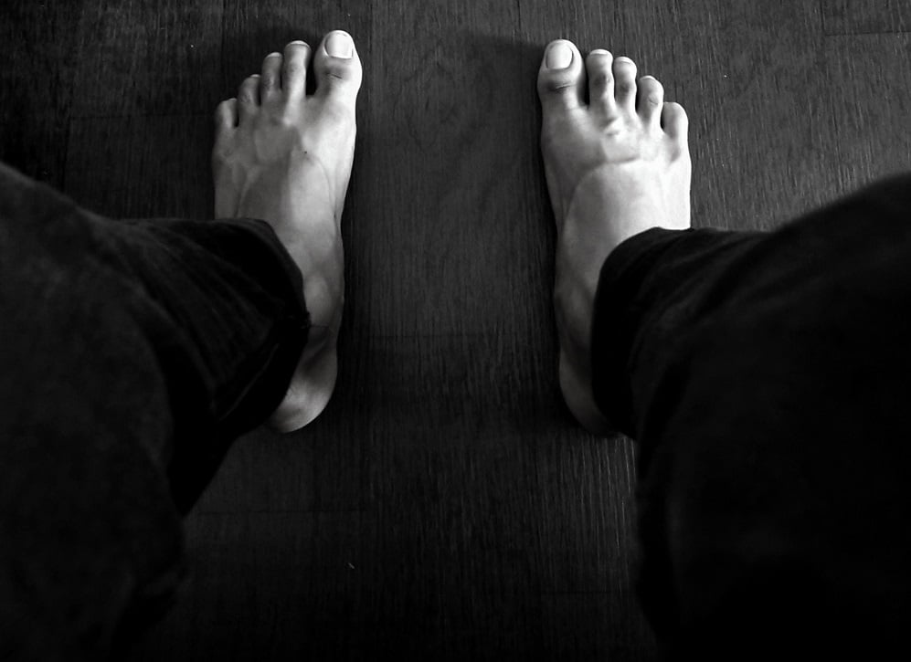 Man standing barefoot on the rug