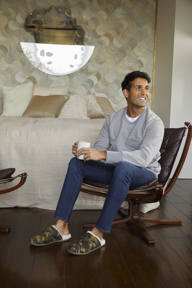 Man sitting at home in comfortable slippers