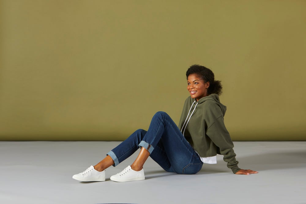 woman sitting with white sneakers