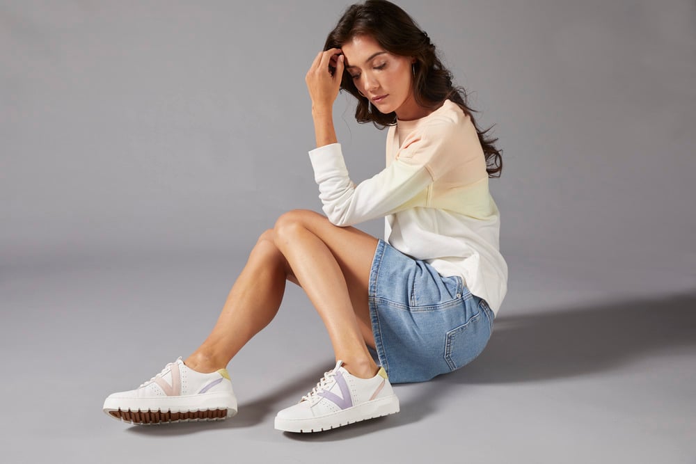 woman sitting with cute sneakers