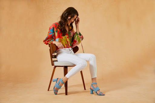 Fashion model woman sitting on a chair and posing